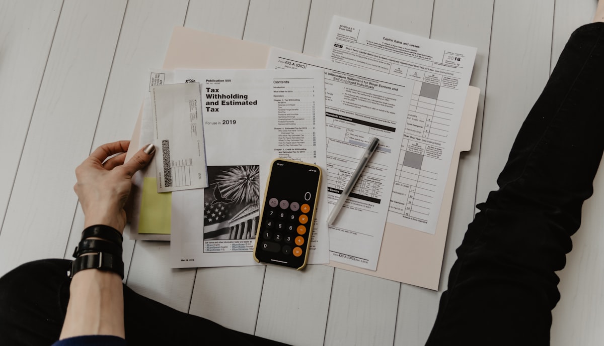 Canadian man at kitchen table with open Bible and laptop showing budget spreadsheet, Christian financial planning